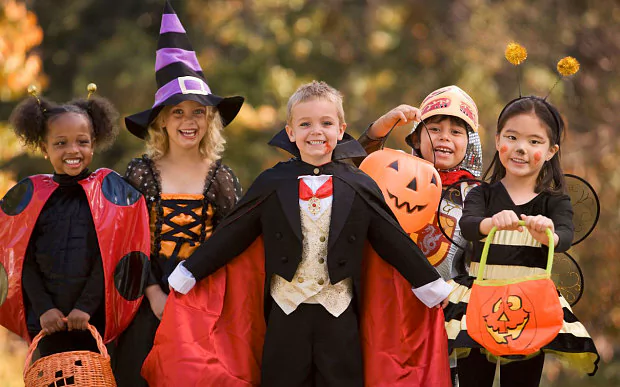 Children showing off their Halloween costumes