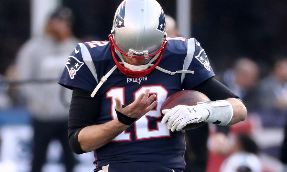 FOXBOROUGH, MA - JANUARY 21: Tom Brady #12 of the New England Patriots looks at his right hand during warm ups before the AFC Championship Game against the Jacksonville Jaguars at Gillette Stadium on January 21, 2018 in Foxborough, Massachusetts. (Photo by Elsa/Getty Images)