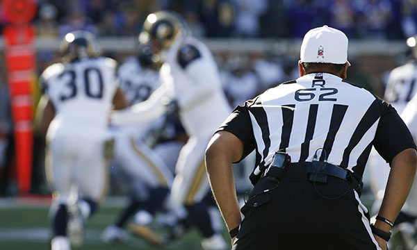 Referee Ronald Torbert (62) looks over the play during the first half of an NFL football game between the Minnesota Vikings and the St. Louis Rams, Sunday, Nov. 8, 2015, in Minneapolis. (AP Photo/Ann Heisenfelt)