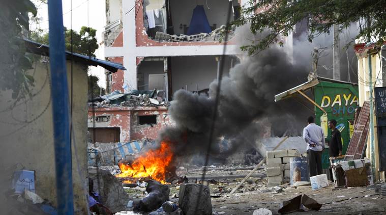 Somali+men+watch+as+fires+burn+amidst+the+destruction+outside+the+Sahafi+Hotel+in+Mogadishu%2C+Somalia+Sunday%2C+Nov.+1%2C+2015.+A+Somali+police+officer+says+an+explosion+followed+by+heavy+gunfire+has+been+heard%2C+thought+to+have+been+caused+by+a+suicide+car+bomb%2C+at+the+hotel+often+frequented+by+Somali+government+officials+and+business+executives.+%28AP+Photo%2FFarah+Abdi+Warsameh%29